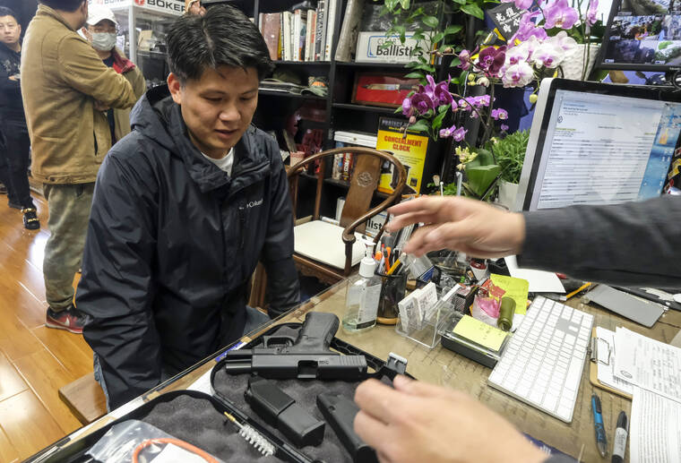 ASSOCIATED PRESS
                                Brian Xia, 44, picked up his gun at a gun store in Arcadia, Calif., in March 2020. A federal appeals court ruled that California’s ban on the sale of semiautomatic weapons to adults under age 21 is unconstitutional.