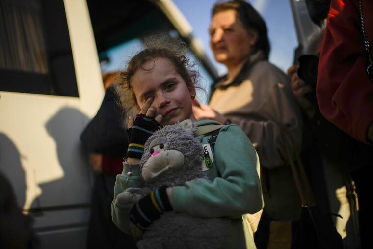 ASSOCIATED PRESS / MAY 8
                                A child and her family who fled from Mariupol arrive at a reception center for displaced people in Zaporizhzhia, Ukraine.