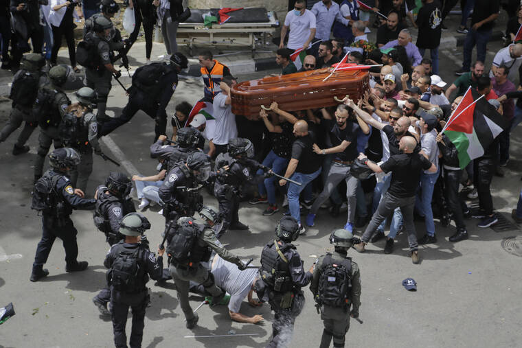 ASSOCIATED PRESS
                                Israeli police confronted with mourners as they carried the casket of slain Al Jazeera veteran journalist Shireen Abu Akleh during her funeral in east Jerusalem, today. Abu Akleh, a Palestinian-American reporter who covered the Mideast conflict for more than 25 years, was shot dead Wednesday during an Israeli military raid in the West Bank town of Jenin.