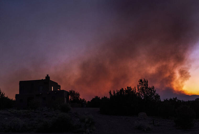 THE ALBUQUERQUE JOURNAL / AP / MAY 6
                                The Cerro Pelado Fire, seen from Cochiti, N.M, burns in the Jemez Mountains.