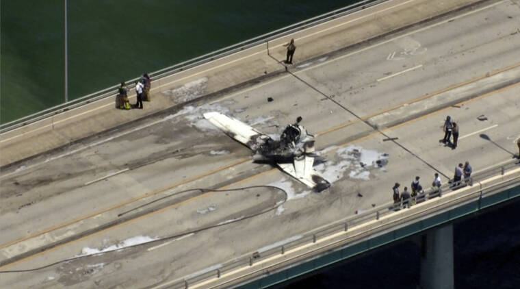 WSVN-TV / AP
                                Emergency personnel respond to a small plane crash in Miami.