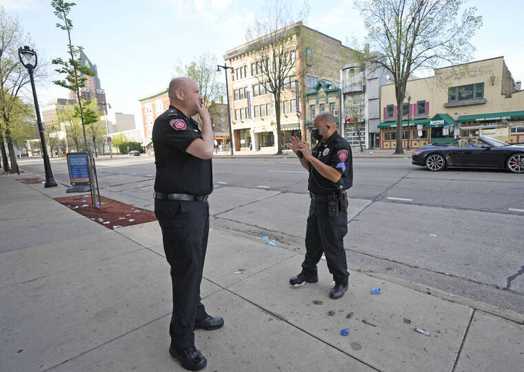 MILWAUKEE JOURNAL-SENTINEL / AP
                                MSOE Public Safety officers investigate the scene of a shooting near the corner of North Water Street and East Juneau Avenue in Milwaukee, Saturday, where multiple were shot and injured late Friday in Milwaukee’s downtown bar district after the Milwaukee Bucks playoff game.
