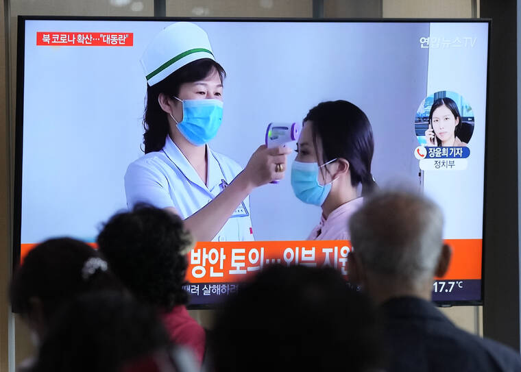 AHN YOUNG-JOON / AP
                                People watch a TV screen showing a news report about the COVID-19 outbreak in North Korea, at a train station in Seoul, South Korea.