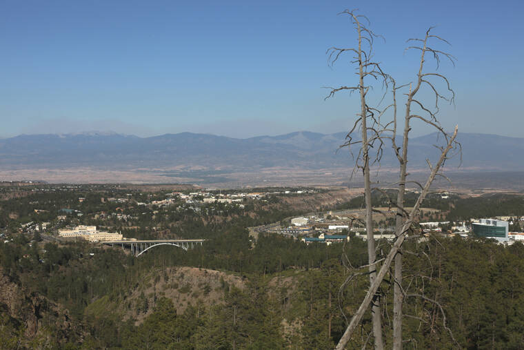 ASSOCIATED PRESS / MAY 12
                                A haze of wildfire smoke hangs over the Upper Rio Grande valley behind the mesa-top city of Los Alamos, N.M. Public schools and many businesses were closed as a wildfire crept closer to the city and companion national security laboratory. Scientists at Los Alamos National Laboratory are using supercomputers and ingenuity to improve wildfire forecasting and forest management amid drought and climate change in the American West.