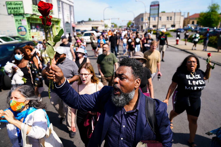 ASSOCIATED PRESS
                                People march at the scene of a shooting at a supermarket in Buffalo, N.Y.