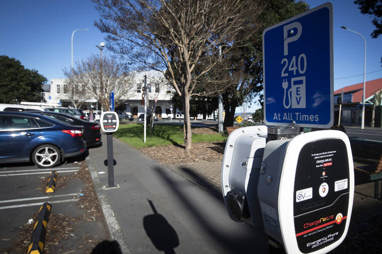 JASON OXENHAM/NEW ZEALAND HERALD VIA AP / 2021
                                Electric vehicle charging stations is seen at a carpark in Auckland, New Zealand. New Zealand will help pay for lower-income families to scrap their old gas guzzlers and replace them with cleaner hybrid or electric cars as part of a sweeping plan to reduce greenhouse gas emissions the government announced Monday, May 16.