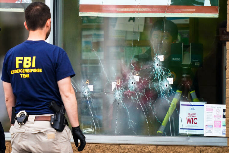 ASSOCIATED PRESS
                                Investigators work today at the scene of Sunday’s deadly shooting at a supermarket in Buffalo, N.Y.