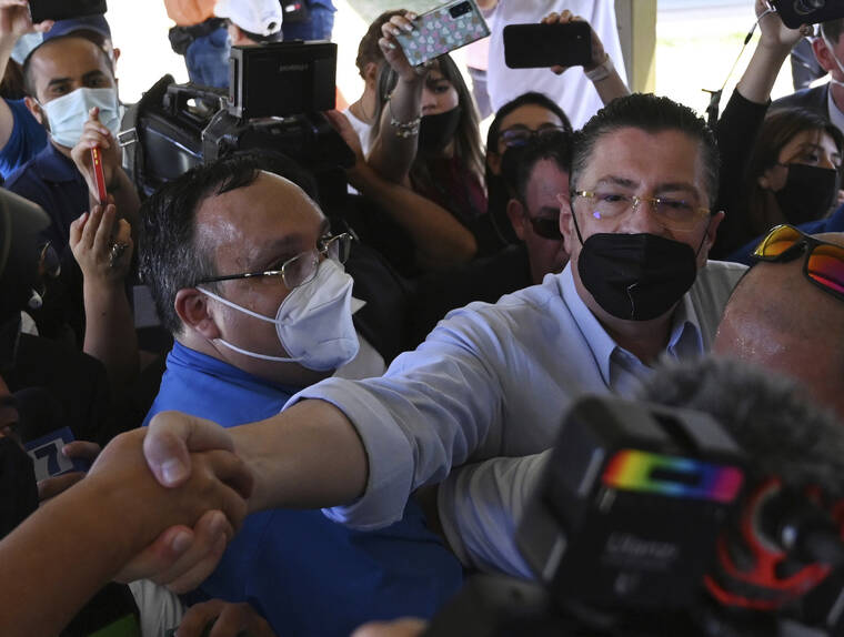FILE - Presidential candidate Rodrigo Chaves greets supporters as he arrives to a polling station during a presidential runoff election in San Jose, Costa Rica, April 3, 2022. Chaves, who won the election, declared a state of emergency over a ransomware attack as soon as he was sworn in early May 2022. (AP Photo/Carlos Gonzalez, File)