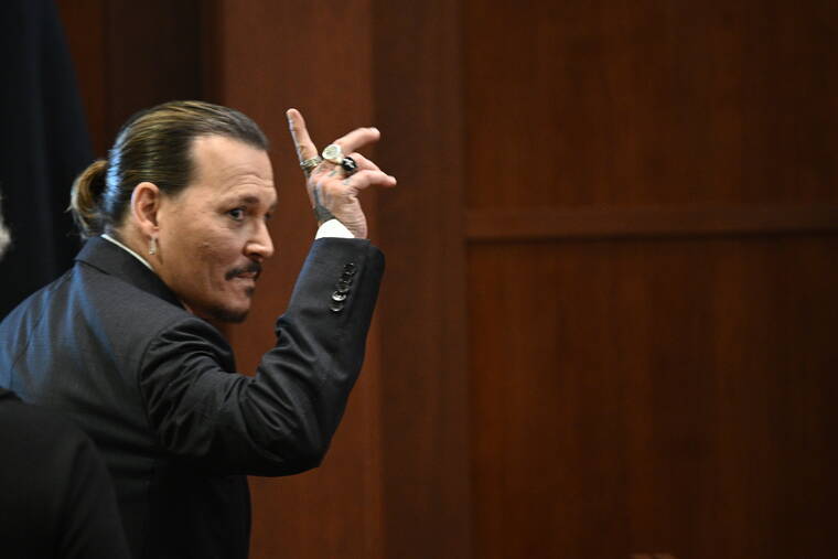 BRENDAN SMIALOWSKI/POOL PHOTO VIA ASSOCIATED PRESS
                                Actor Johnny Depp gestured as he walked out of the courtroom during a break at the Fairfax County Circuit Courthouse in Fairfax, Va., today. Actor Johnny Depp sued his ex-wife Amber Heard for libel in Fairfax County Circuit Court after she wrote an op-ed piece in The Washington Post in 2018 referring to herself as a “public figure representing domestic abuse.”