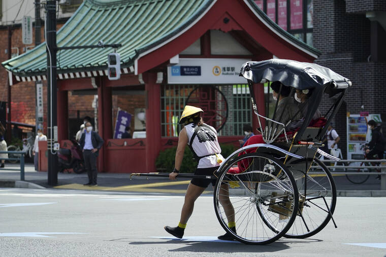 ASSOCIATED PRESS / 2021
                                A rickshaw puller carries tourists near Sensoji Buddhist temple at Tokyo’s Asakusa district in Tokyo, March 31, 2021. Japan’s government announced Tuesday, May 17, it will begin allowing small package tours from four countries in later this month before gradually opening up to foreign tourism for the first time since it imposed tight border restrictions due to the coronavirus pandemic.