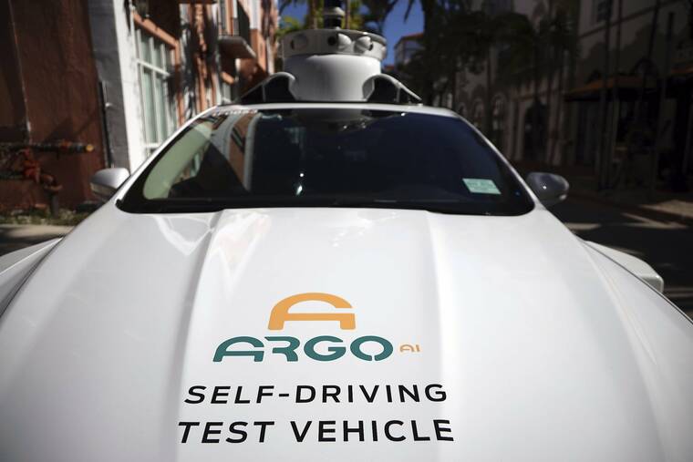 CARL JUSTE/MIAMI HERALD VIA AP / 2020
                                An experimental autonomous vehicle arrives for a drop-off in Miami Beach, Fla. The autonomous vehicle technology company that partners with Ford and Volkswagen said it has started driverless operations in two of eight cities where it is developing its technology. Pittsburgh-based Argo AI has pulled drivers from its autonomous cars in Miami and Austin, though it is still in the testing phase. Its commercial partnerships with Walmart and Lyft still have backup drivers in both cities.