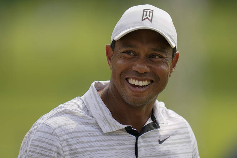 ASSOCIATED PRESS
                                Tiger Woods smiled on the driving range before a practice round for the PGA Championship golf tournament, today, in Tulsa, Okla.