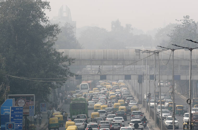 ASSOCIATED PRESS
                                A pedestrian walked on a bridge above vehicle traffic in New Delhi, India, in November 2019, as the city was enveloped under thick smog. The air quality index exceeded 400, about eight times the recommended maximum.