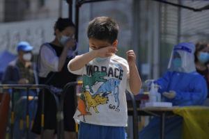 ANDY WONG / AP
                                A child rubs his eyes after getting a COVID-19 test during a public testing on Tuesday in Beijing.