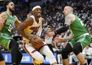 ASSOCIATED PRESS
                                Miami Heat forward Jimmy Butler drove to the basket between Boston Celtics guard Derrick White (9) and center Daniel Theis (27) during the second half of Game 1 of an NBA basketball Eastern Conference finals playoff series, Tuesday, in Miami.
