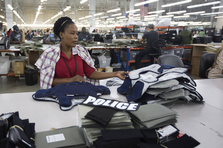 ASSOCIATED PRESS / 2014
                                Laurette Eugene assembles a body armor vest at the Point Blank Body Armor factory in Pompano Beach, Fla. When a shooter attacked a supermarket in Buffalo, New York, May 14, its security guard tried to stop him. At least one of the guard’s shots hit the gunman, but it didn’t stop the deadly rampage because the gunman was wearing body armor.