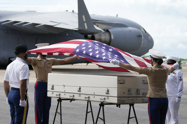 SAKCHAI LALIT / AP
                                U.S. military drape a national flag over the possible remains of a WWII U.S. airman found in northern Thailand, during a repatriation ceremony at the U-Tapao Air Base in Rayong province, eastern Thailand.