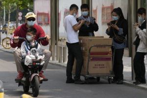 ASSOCIATED PRESS
                                Residents wearing masks are seen on the street on Thursday in Beijing.