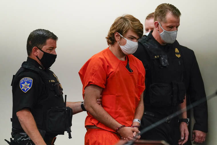 ASSOCIATED PRESS
                                Payton Gendron was led into the courtroom for a hearing at Erie County Court, in Buffalo, N.Y., today. Gendron appeared in court today, standing silently during a brief proceeding attended by some relatives of the victims after a grand jury indicted him.