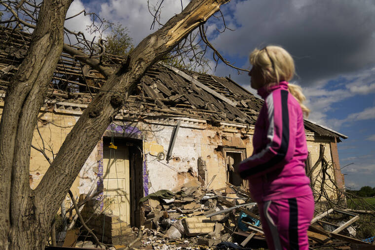 ASSOCIATED PRESS
                                Iryna Martsyniuk, 50, stood next to her heavily damaged house after a Russian bombing in Velyka Kostromka village, Ukraine, today. Martsyniuk and her three young children were at home when the attack occurred in the village, a few kilometres from the front lines, but they all survived unharmed.