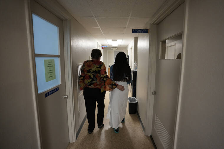 ASSOCIATED PRESS
                                A 33-year-old mother of three from central Texas was escorted down the hall by clinic administrator Kathaleen Pittman prior to getting an abortion, in October 2021, at Hope Medical Group for Women in Shreveport, La. Reproductive rights advocates are planning to open new abortion clinics or expand the capacity of existing ones in states without restrictive abortion laws.