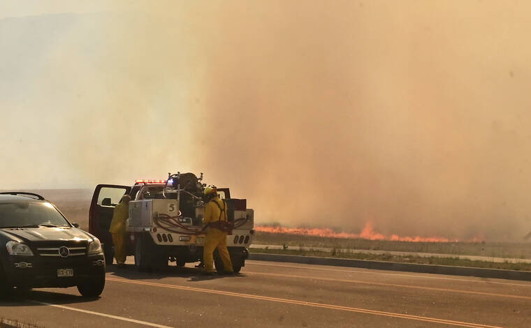 THE GAZETTE / AP / MAY 12
                                A firefighting crew arrives at the scene of a field on fire adjacent to the Amazon Distribution Center in Colorado Springs, Colo..