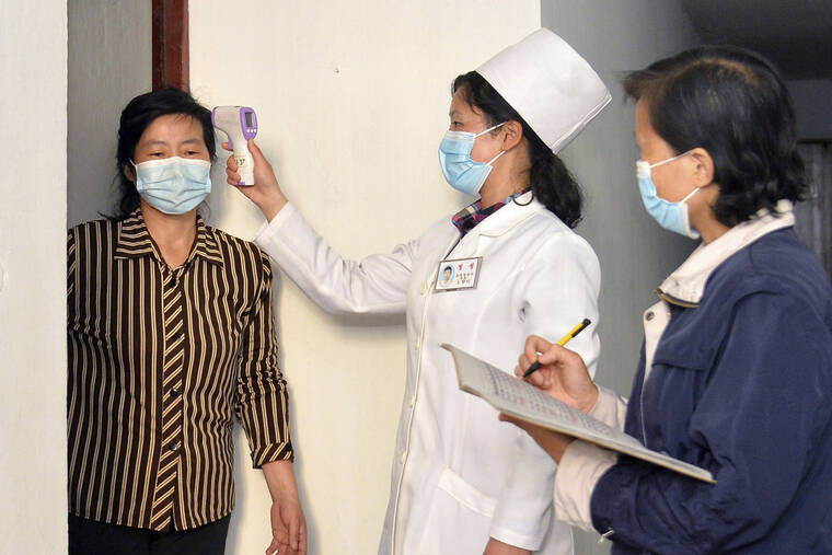 KOREAN CENTRAL NEWS AGENCY / KOREA NEWS SERVICE / AP
                                In this photo provided by the North Korean government, a doctor checks a resident’s temperature to curb the spread of coronavirus infection, in Pyongyang, North Korea on May 17.