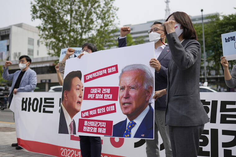 ASSOCIATED PRESS
                                Members of the Progressive Party shout slogans during a rally demanding the withdrawal of the government’s anti-North Korea policies near the presidential office in Seoul, South Korea, today. The letters read, “Withdrawal the hostile policies towards North Korea.”