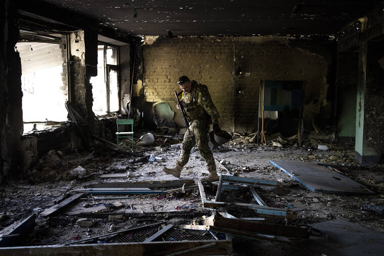 ASSOCIATED PRESS
                                A Ukrainian serviceman inspected a school damaged during a battle between Russian and Ukrainian forces in the village of Vilkhivka, on the outskirts of Kharkiv, in eastern Ukraine, today.