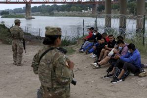 ASSOCIATED PRESS
                                Migrants who crossed the Rio Grande river into the U.S. were under custody of National Guard members as they awaited the arrival of U.S. Border Patrol agents in Eagle Pass, Texas, today. A federal judge in Louisiana is refusing to end pandemic-related restrictions on migrants seeking asylum on the southern border.