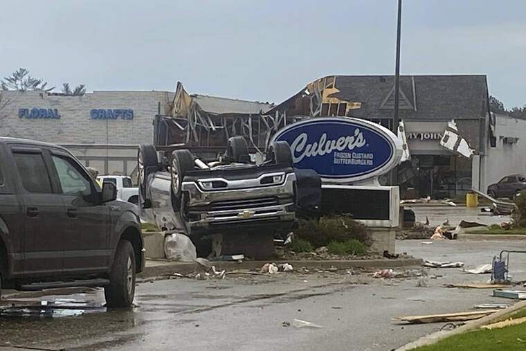 STEVEN BISCHER VIA AP
                                An upended vehicle following an apparent tornado in Gaylord, Mich.