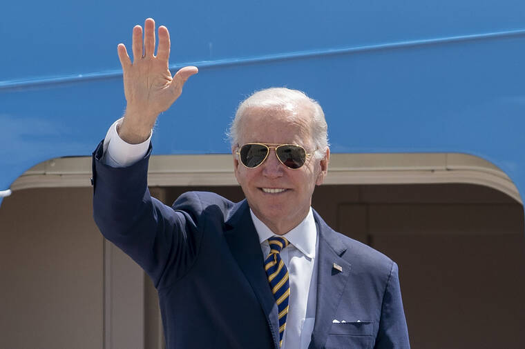 ASSOCIATED PRESS
                                President Joe Biden waves as he boards Air Force One for a trip to South Korea and Japan on Thursday.