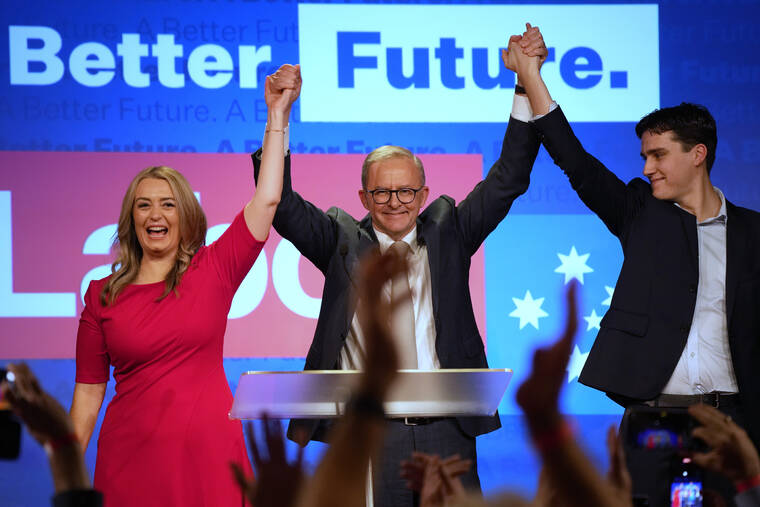 RICK RYCROFT / AP
                                Labor Party leader Anthony Albanese, center, celebrates with his son Nathan, right, and his partner Jodie Haydon at a Labor Party event in Sydney, Australia after Prime Minister Scott Morrison conceding defeat to Albanese in a federal election.