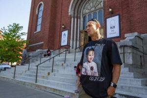 LAUREN PETRACCA / AP
                                Enrique Owens, a cousin of Roberta Drury, wears a t-shirt with her photograph on it before her funeral service in Syracuse, N.Y.