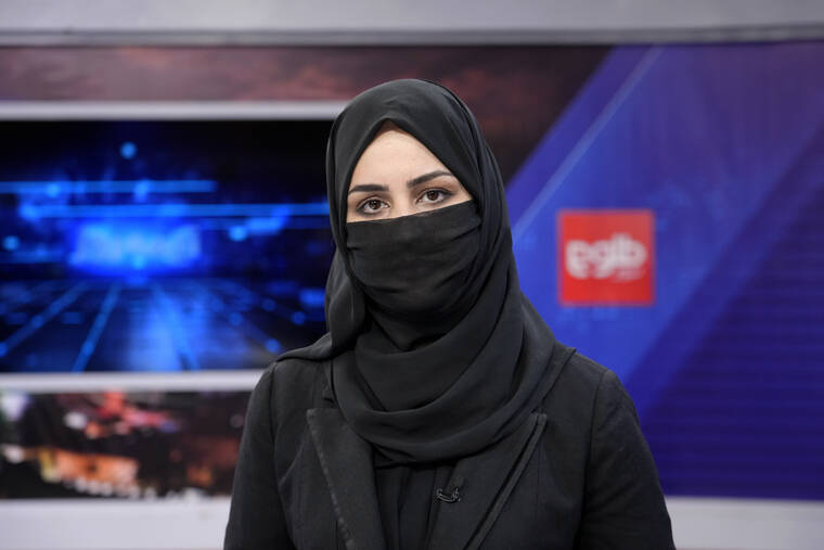 ASSOCIATED PRESS
                                Khatereh Ahmadi a TV anchor wears a face covering as she reads the news on TOLO NEWS, in Kabul, Afghanistan. Afghanistan’s Taliban rulers have begun enforcing an order requiring all-female TV news anchors in the country to cover their faces while on-air. The move Sunday is part of a hard-line shift drawing condemnation from rights activists.