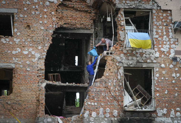 ASSOCIATED PRESS
                                Residents take out their belongings from their houses ruined by the Russian shelling in Irpin close to Kyiv, Ukraine.