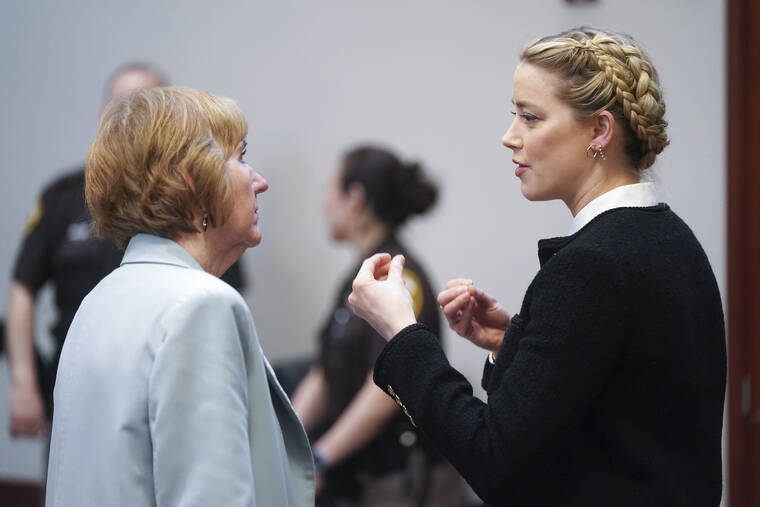 SHAWN THEW/POOL PHOTO VIA AP / MAY 19
                                Actor Amber Heard speaks with her attorney Elaine Bredehoft during a break at the Fairfax County Circuit Courthouse in Fairfax, Va. Actor Johnny Depp sued his ex-wife Amber Heard for libel in Fairfax County Circuit Court after she wrote an op-ed piece in The Washington Post in 2018 referring to herself as a “public figure representing domestic abuse.”