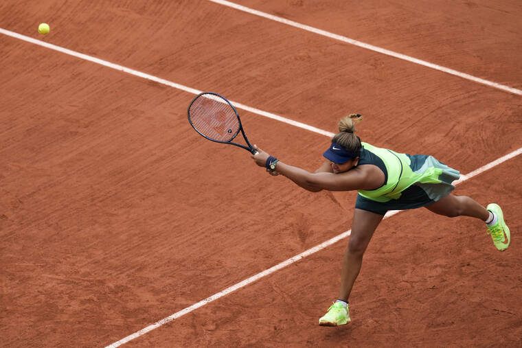 ASSOCIATED PRESS
                                Japan’s Naomi Osaka played a shot against Amanda Anisimova of the U.S. during their first round match at the French Open tennis tournament in Roland Garros stadium in Paris, France, today.