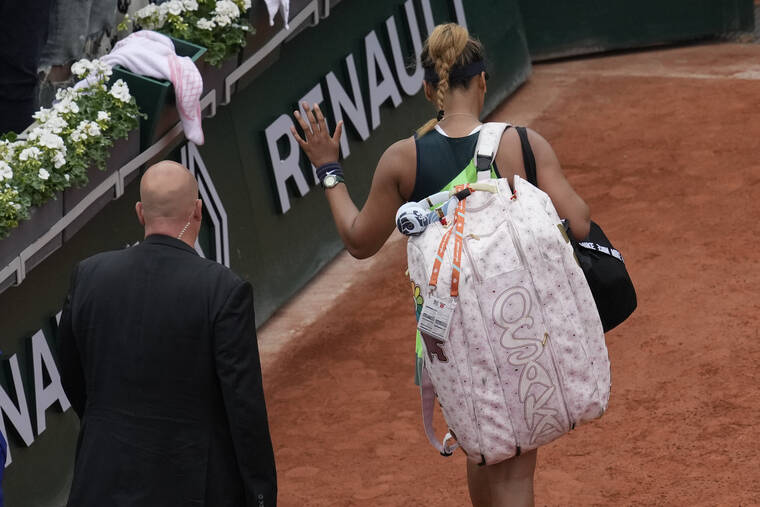 ASSOCIATED PRESS
                                Japan’s Naomi Osaka left after losing against Amanda Anisimova of the U.S. during their first round match at the French Open tennis tournament in Roland Garros stadium in Paris, France, today.