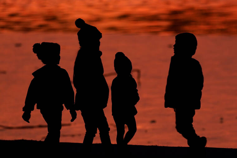 ASSOCIATED PRESS
                                Kids were silhouetted against a pond at a park in Lenexa, Kan., in December 2020. Health officials remain perplexed by mysterious cases of severe liver damage in hundreds of young children around the world.