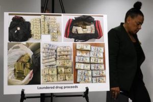 ASSOCIATED PRESS
                                U.S. Attorney Rachael Rollins, of the Massachusetts District, walks past evidence photographs showing bundles of currency at the Moakley Federal Courthouse in Boston. Nineteen people were indicted in a complex money laundering scheme to move millions of dollars in drug proceeds from Colombian cartels through U.S. banks.