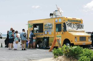 ASSOCIATED PRESS
                                Tourists lined up Monday to order from a food truck parked near Waikiki Beach.
