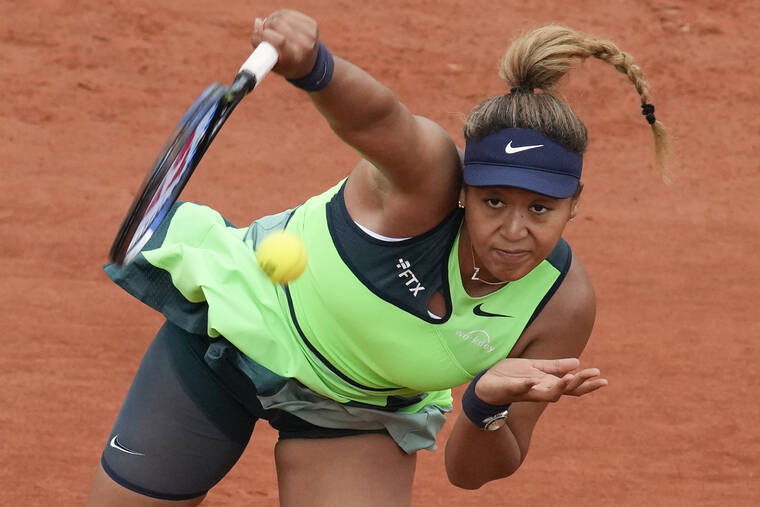 ASSOCIATED PRESS
                                Japan’s Naomi Osaka serves against Amanda Anisimova of the U.S. during their first-round match at the French Open on Monday.