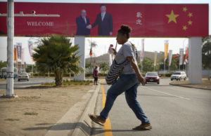 ASSOCIATED PRESS
                                A woman crosses the street near a billboard commemorating the state visit of Chinese President Xi Jinping in Port Moresby, Papua New Guinea, Nov. 15, 2018. China wants 10 small Pacific nations to endorse a sweeping agreement covering everything from security to fisheries in what one leader warns is a “game-changing” bid by Beijing to wrest control of the region.