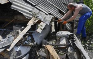 ASSOCIATED PRESS
                                A resident removed debris from a destroyed house after Russian shelling in Kramatorsk, Ukraine, today.