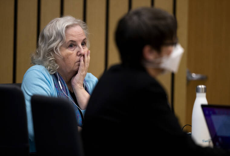 POOL PHOTO / AP / APRIL 4
                                Romance writer Nancy Crampton Brophy, left, accused of killing her husband, Dan Brophy, in June 2018, watches proceedings in court in Portland, Ore.