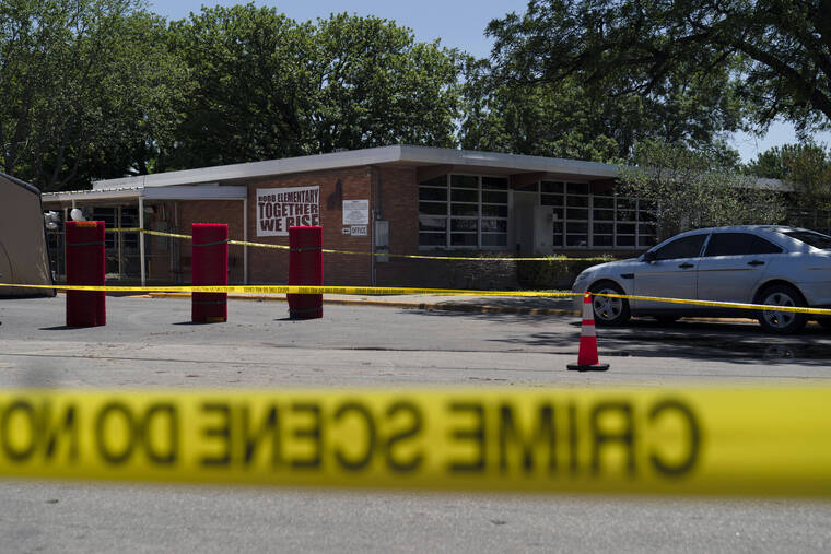 ASSOCIATED PRESS
                                Crime scene tape surrounds Robb Elementary School in Uvalde, Texas, Wednesday. Desperation turned to heart-wrenching sorrow for families of grade-schoolers killed after an 18-year-old gunman barricaded himself in their Texas classroom and began shooting, killing at least 19 fourth-graders and their two teachers.