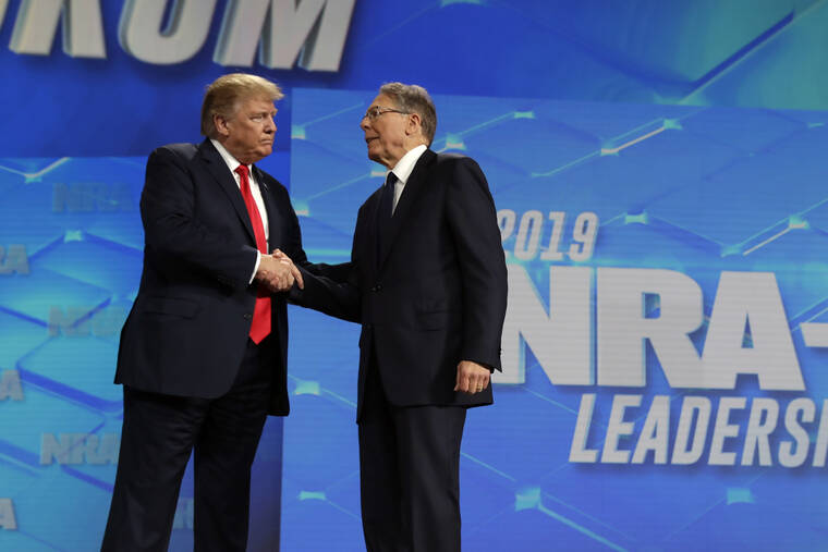 ASSOCIATED PRESS / 2019
                                Then-President Donald Trump shakes hands with NRA executive vice president and CEO Wayne LaPierre, has he arrives to speak to the annual meeting of the National Rifle Association in Indianapolis. The National Rifle Association is going ahead with its annual meeting in Houston just days after the shooting massacre at a Texas elementary school that left 19 children and 2 teachers dead. With protests planned outside, former President Donald Trump and other leading GOP figures, including South Dakota Gov. Kristi Noem, will address attendees.