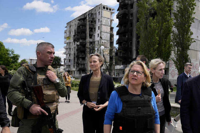 German Development Minister Svenja Schulze visits a destroyed area in Borodyanka, in the outskirts of Kyiv, Ukraine, Friday, May 27, 2022. (AP Photo/Natacha Pisarenko)