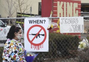 JERILEE BENNETT/THE GAZETTE VIA ASSOCIATED PRESS
                                Tanice Cisneros walks by an anti-gun sign on the way to leave flowers for her friend, Rikki Olds on Tuesday, March 23, 2021. Olds was a King Soopers employee that was killed at the Boulder King Soopers on Monday.